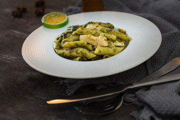 Pasta with pesto sauce and nuts on a the table