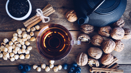 Flat lay of Cup of te and iron with dried fruit tea, cinnamon and fruits of the forest. vintage style