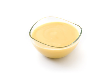 Bowl of homemade vanilla custard isolated on white background


