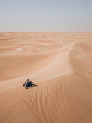 Fototapeta na wymiar Riding a Quad through the endless desert