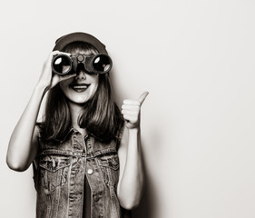 Portrait of young style hipster girl with binoculars . Image in black and white color style
