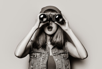 Portrait of young style hipster girl with binocular . Image in black and white color style