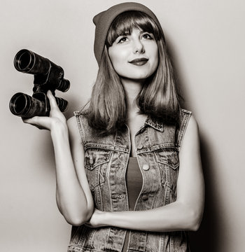 Portrait of young style hipster girl with binocular . Image in black and white color style