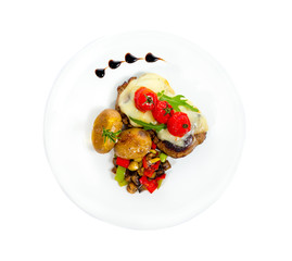 Pork Medallions with Potato and Mushrooms isolated on white.