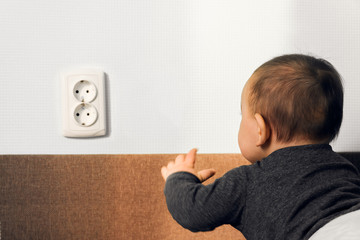 child crawl put fingers electric socket wall outlet hazard danger safety home