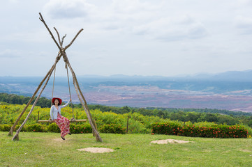 women happy playing swing.