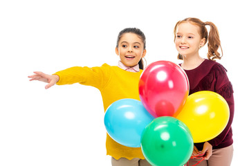 Fototapeta na wymiar cheerful schoolgirls holding colorful balloons isolated on white