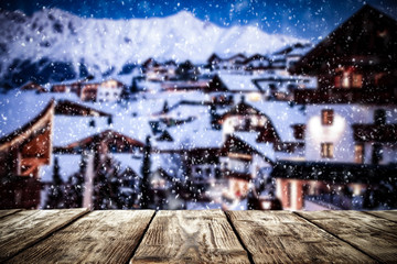 Fototapeta premium Old wooden table in the snowy mountains. Alps with a free place for an advertising product 