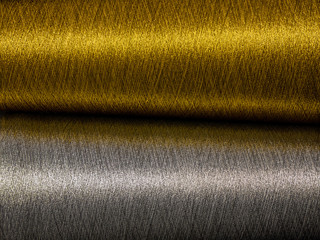 Gold and silver sewing threads background - close-up	