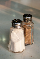 Containers with salt and pepper in restaurant in latin america, natural light.