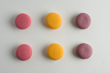 Cake macaron or macaroon on white background from above, colorful almond cookies, top view.