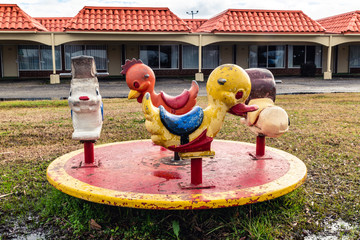 Old broken down playground equipment in a derelict children's playground