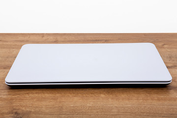 Computer isolated on wooden background.