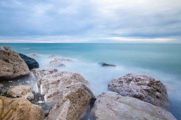 long exposure of misty sea and rocks