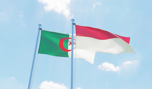 Algeria and Indonesia, two flags waving against blue sky. 3d image