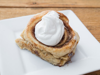 Homemade cinnamon roll swirl bun with fresh whipped frosting. A sugar filled treat for breakfast or brunch.