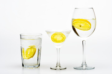 Detox drink to feel better. Hangover and detox. Detox after party. Health care concept. What to drink on party. Cocktail glasses with water slice of lemon isolated on white. Alcohol harmful influence