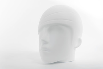 White plastic human head from mannequin as soft object with shadows, shades of gray, mild style...