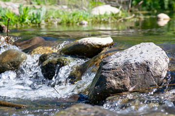 Fototapeta na wymiar river waterfall in the forest. a small waterfall through the stones. against the backdrop of mountains and forests. long exposure
