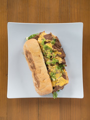 Philly cheesesteak with melted cheese.