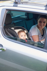 Mother with small kid on back car seat