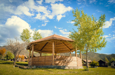 wooden gazebo against the sky. small arbor. bottom view. around the mountain