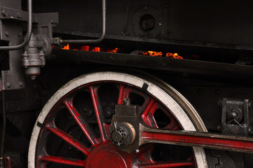 Red-hot coal in furnace and red wheel of a steam locomotive