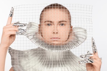 Futuristic woman dressed in iron clothes and with fingers rolled up in foil