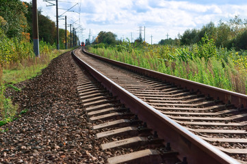 Fototapeta na wymiar Rails stretching into the distance. Turn at the railroad.