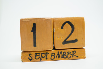 september 12th. Day 12 of month, handmade wood calendar isolated on white background. autumn month, day of the year concept