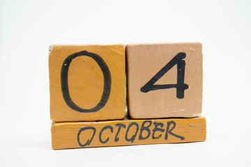 october 4th. Day 4 of month, handmade wood calendar isolated on white background. autumn month, day of the year concept