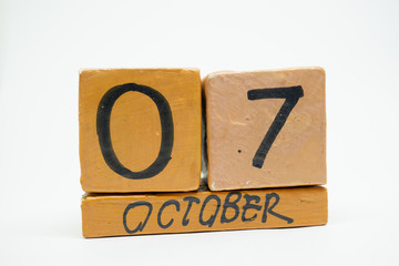 october 7th. Day 7 of month, handmade wood calendar isolated on white background. autumn month, day of the year concept