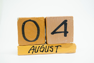 august 4th. Day 4 of month, handmade wood calendar isolated on white background. summer month, day of the year concept