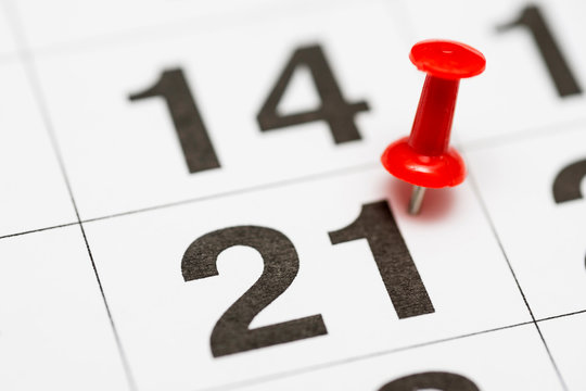 Pin on the date number 21. The twenty first day of the month is marked with a red thumbtack. Pin on calendar