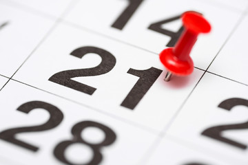 Pin on the date number 21. The twenty first day of the month is marked with a red thumbtack. Pin on calendar