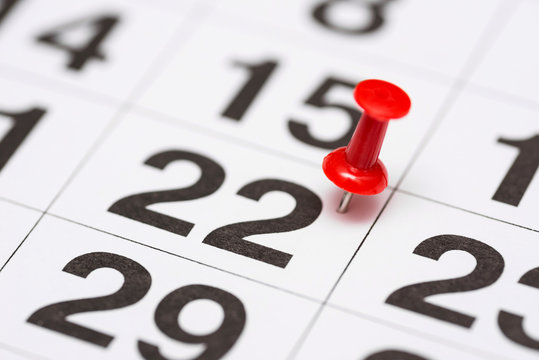 Pin on the date number 22. The twenty second day of the month is marked with a red thumbtack. Pin on calendar