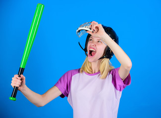 Baseball female player concept. Break sport stereotype. Woman enjoy play baseball game. Woman in baseball sport. Girl confident pretty blonde wear baseball helmet and hold bat on blue background