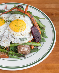 Healthy breakfast salad with egg on top