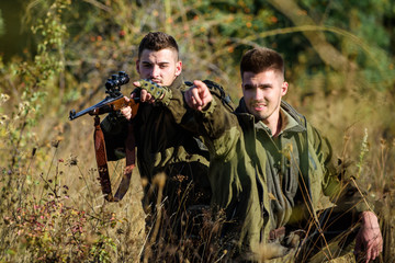 Hunters with rifles in nature environment. Hunters gamekeepers looking for animal or bird. Hunting...