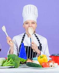 Cooking healthy food. Woman chef cooking healthy food. Fresh vegetables ingredients for cooking meal. Gourmet main dish recipes. Cooking is her hobby. Girl in hat and apron. Delicious recipe concept