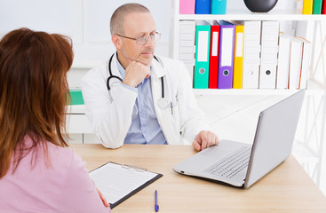doctor and patien sitting in gospital office, helping people