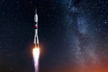 Rocket against the starry sky. The concept of space exploration, satellite launch, flight to the moon, flight to Mars, free internet. Elements of this image furnished by NASA. Mixed media