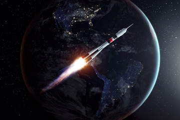 The rocket flies in space against the backdrop of the earth. The concept of space exploration,...