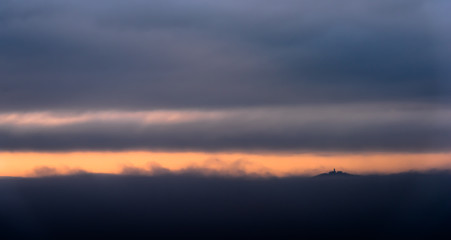 The castle enveloped by the fog in orange light
