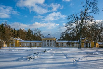 Winter scene of yellow building of Ferdinand colonnade with mineral water at spa town Marienbad,...