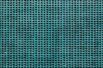 Construction protective mesh against dust and debris. Turquoise background.