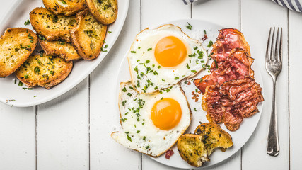 bacon and eggs for breakfast with chives and bread