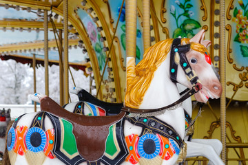 Carousel with rocking horses in the park. Children's carousel is closed for the winter season. © elena