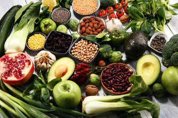 Healthy food clean eating selection. fruit, vegetable, seeds, superfood, cereals, leaf vegetable on rustic background