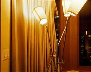 A lamp and a curtain in an interior of a hotel room